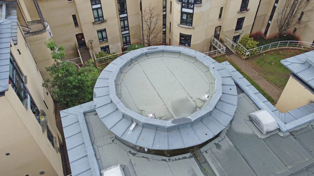 Completed circular flat roof after Central Group refurbishment, showing new waterproofing and flashing details.