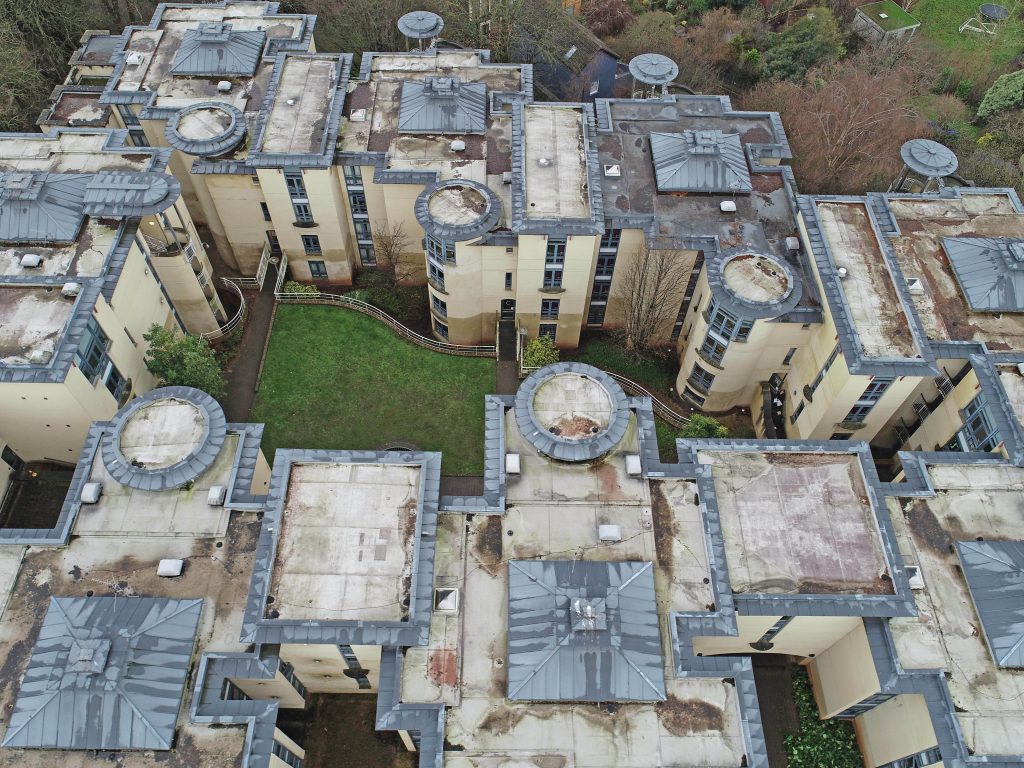 Top-down view of roof before Central Group’s refurbishment, showing damaged membrane and old materials.